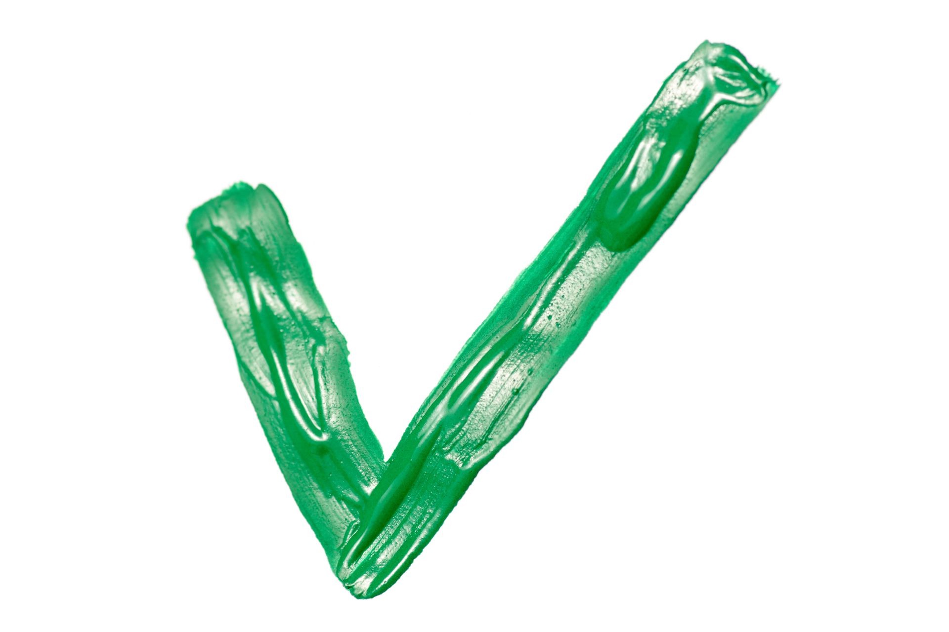 Check mark with green paint on white background isolation